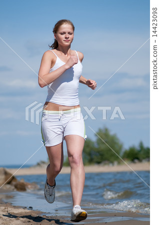 Sport woman running in sea coast 14423098