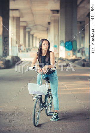 young beautiful brunette straight hair woman using bike 14423946