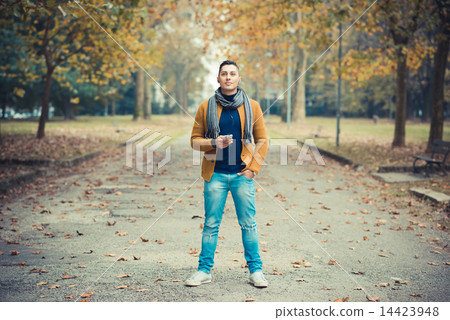 young handsome caucasian man in autumn park 14423948