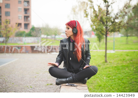 young beautiful red hair venezuelan woman lifestyle listening mu 14423949