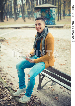 young handsome caucasian man in autumn park 14424069
