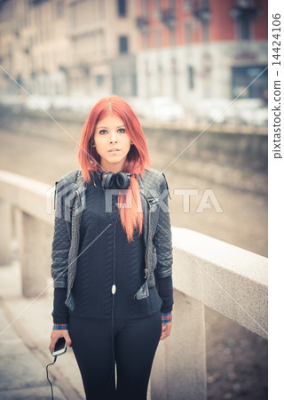 young beautiful red hair venezuelan woman lifestyle listening mu 14424106