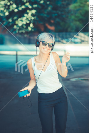 young beautiful short blue hair hipster woman with headphones mu 14424133