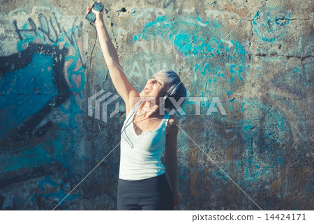 young beautiful short blue hair hipster woman with headphones mu 14424171