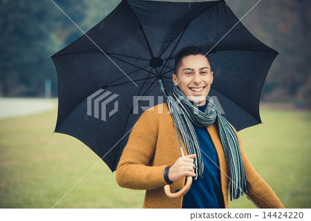 young handsome caucasian man in autumn park young handsome caucasian man in autumn park 14424220
