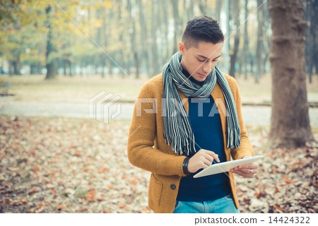 young handsome caucasian man in autumn park young handsome caucasian man in autumn park 14424322