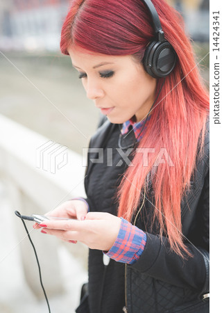 young beautiful red hair venezuelan woman lifestyle listening mu 14424341