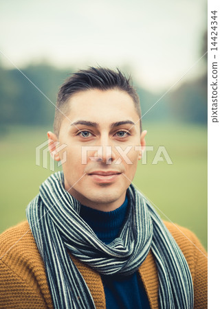 young handsome caucasian man in autumn park young handsome caucasian man in autumn park 14424344