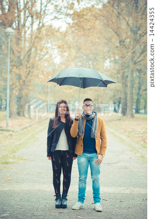 young couple in the park during autumn season outdoor 14424355