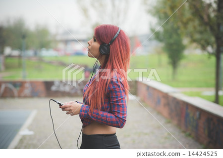 young beautiful red hair venezuelan woman lifestyle listening mu 14424525