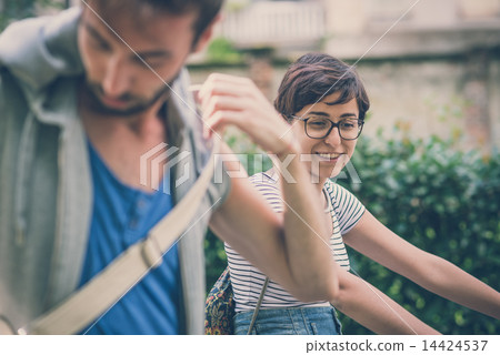 couple of friends young man and woman riding bike 14424537