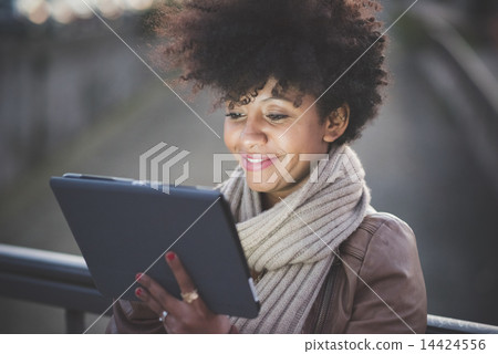 beautiful black curly hair african woman using tablet 14424556