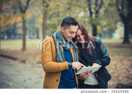 young couple in the park during autumn season outdoor young couple in the park during autumn season outdoor 14424566