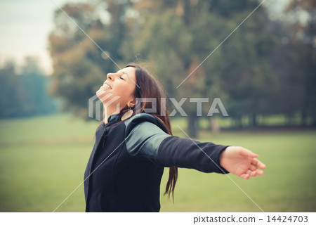 young beautiful brunette straight hair woman in the park 14424703