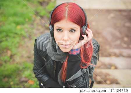 young beautiful red hair venezuelan woman lifestyle listening mu 14424789