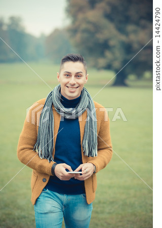 young handsome caucasian man in autumn park young handsome caucasian man in autumn park 14424790