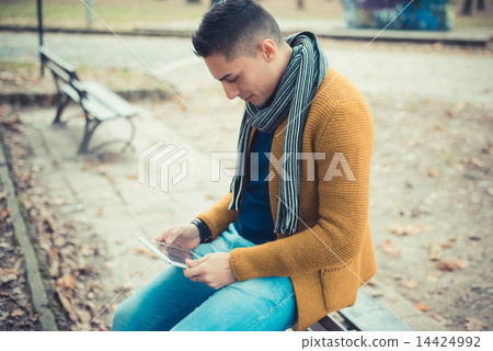 young handsome caucasian man in autumn park 14424992