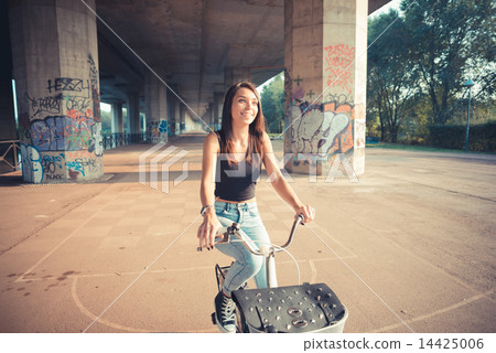 young beautiful brunette straight hair woman using bike 14425006