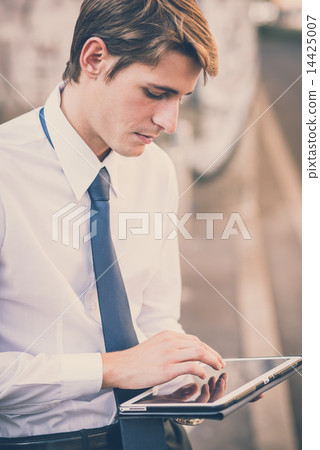 young handsome elegant blonde model man using tablet 14425007