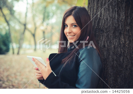 young beautiful brunette straight hair woman in the park 14425056