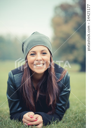 young beautiful brunette straight hair woman in the park 14425177