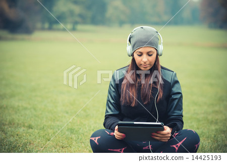 young beautiful brunette straight hair woman in the park 14425193