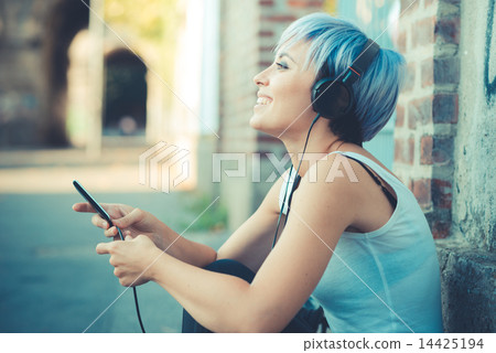 young beautiful short blue hair hipster woman with headphones mu 14425194