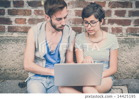 couple of friends young man and woman using laptop 14425195