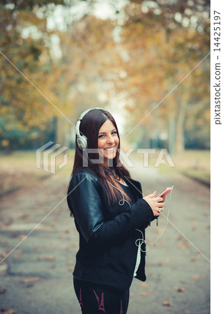 young beautiful brunette straight hair woman in the park 14425197
