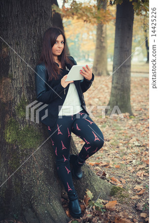 young beautiful brunette straight hair woman in the park 14425226