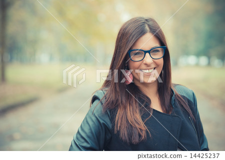young beautiful brunette straight hair woman in the park 14425237