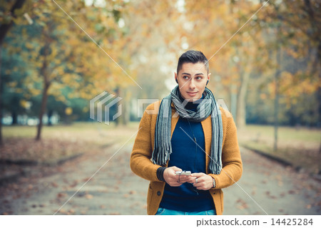 young handsome caucasian man in autumn park young handsome caucasian man in autumn park 14425284