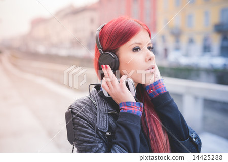 young beautiful red hair venezuelan woman lifestyle listening mu 14425288