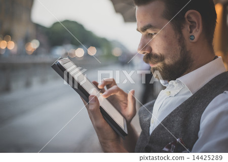 handsome big moustache hipster man using tablet 14425289