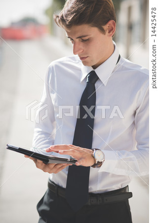 young handsome elegant blonde model man using tablet 14425478