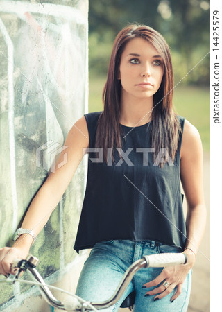 young beautiful brunette straight hair woman using bike 14425579