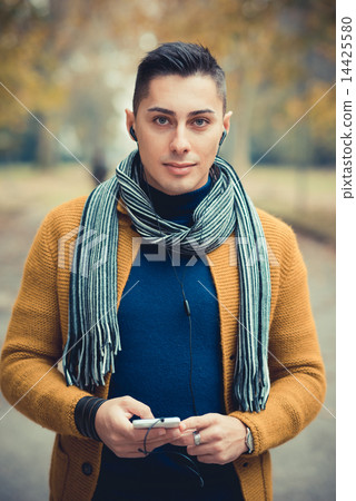 young handsome caucasian man in autumn park 14425580