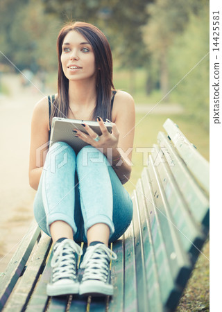 young beautiful brunette straight hair woman using tablet 14425581