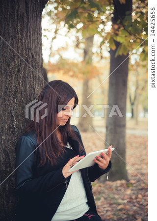 young beautiful brunette straight hair woman in the park 14425658