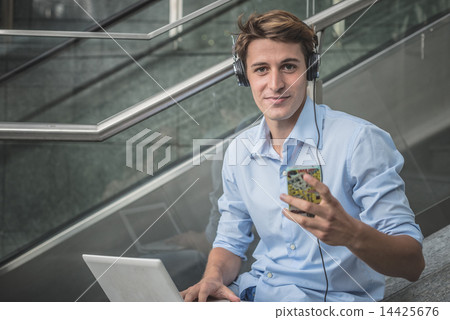 young model hansome blonde man headphone and notebook 14425676