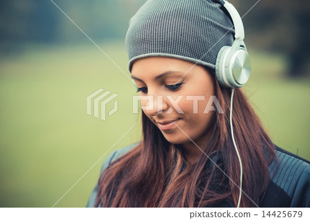 young beautiful brunette straight hair woman in the park 14425679