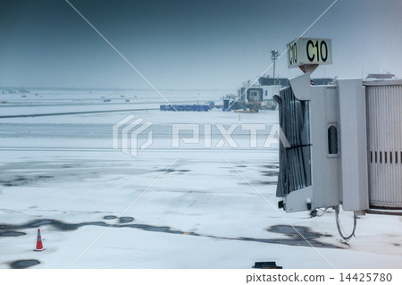 Empty airport aerobridge in winter weather at an airport 14425780