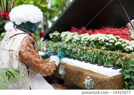 Sculpture of man playing a piano alone in Allan Gardens during the Christmas season, Toronto, Ontario, Canada 14425877