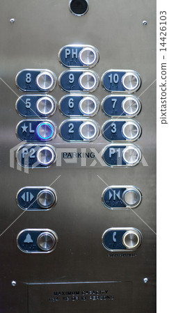 Full frame of numbered buttons with braille markings on elevator panel 14426103
