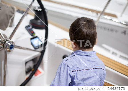 Rear view of a boy traveling in a yacht Rear view of a boy traveling in a yacht 14426173