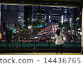 A woman standing at the station's home and a city at night 14436765
