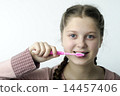 Cute girl brushing teeth on white 14457406