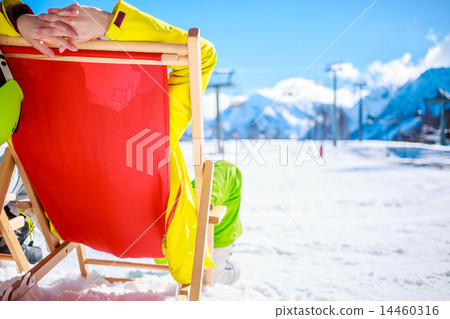 Women at mountains in winter lies on sun-lounger 14460316