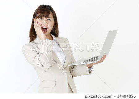 A woman shocked by a laptop 14494850