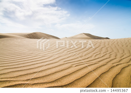 Blue sky and sand dunes with footprints. 14495367